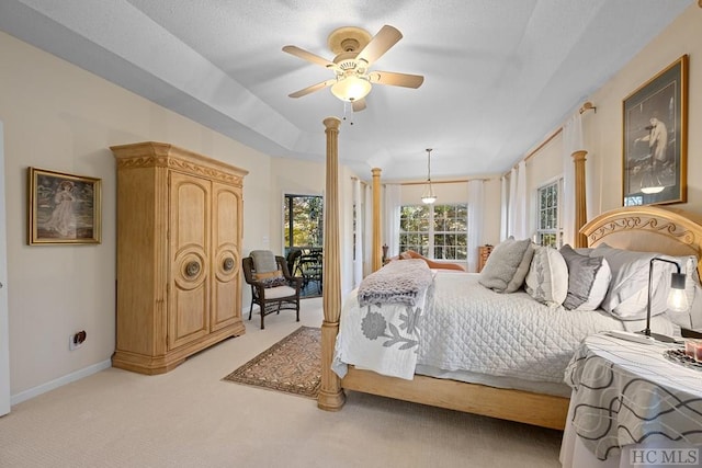 bedroom featuring access to exterior, light carpet, ceiling fan, and a raised ceiling