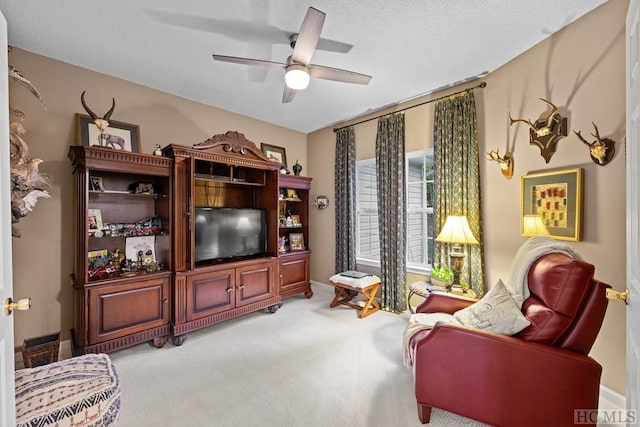 living room with light carpet, a textured ceiling, and ceiling fan