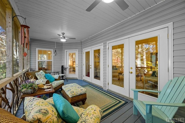 sunroom / solarium with a wealth of natural light, ceiling fan, and french doors