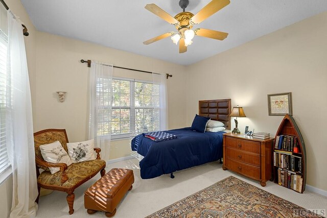 carpeted bedroom featuring ceiling fan