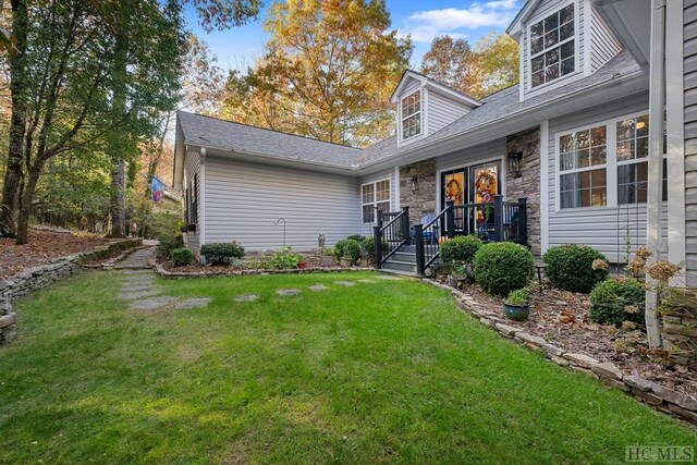 rear view of property with a yard