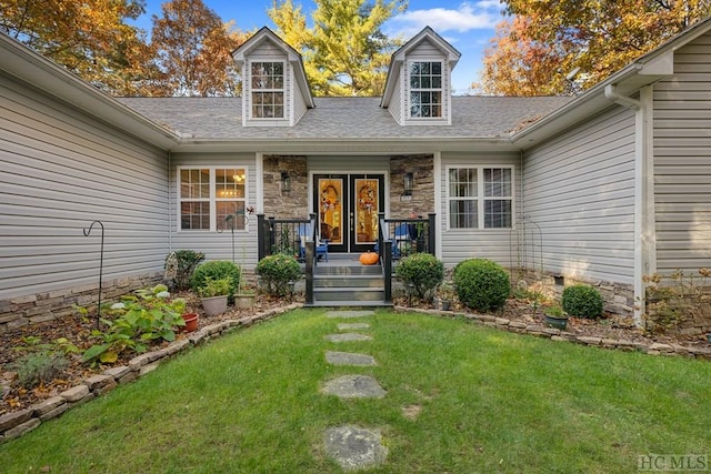 property entrance with a lawn and french doors