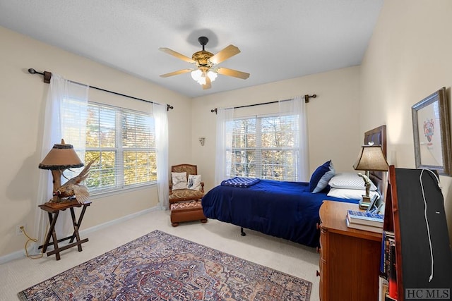 bedroom featuring light colored carpet and ceiling fan