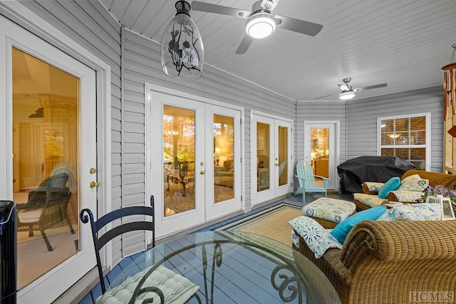 sunroom / solarium featuring french doors and ceiling fan