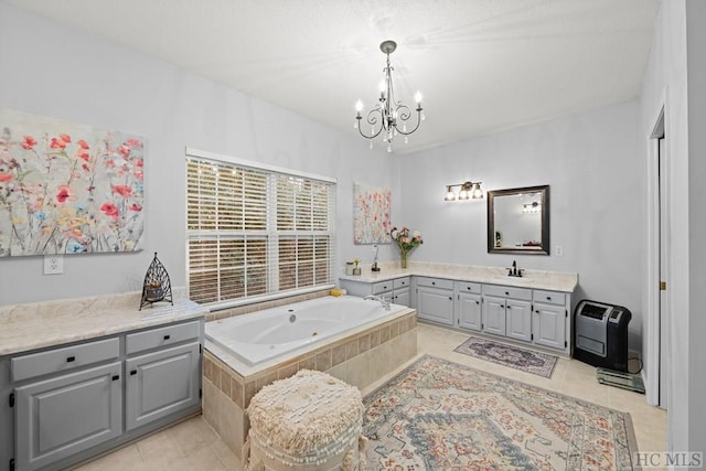 bathroom featuring tile patterned floors, heating unit, an inviting chandelier, vanity, and tiled tub