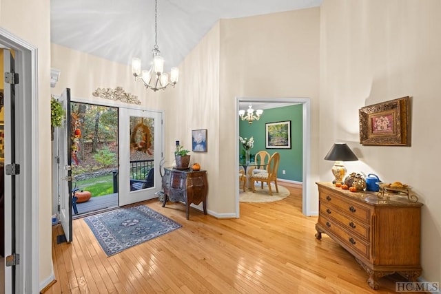 foyer with a notable chandelier and light wood-type flooring