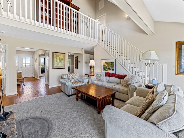 living room with a high ceiling and dark hardwood / wood-style floors