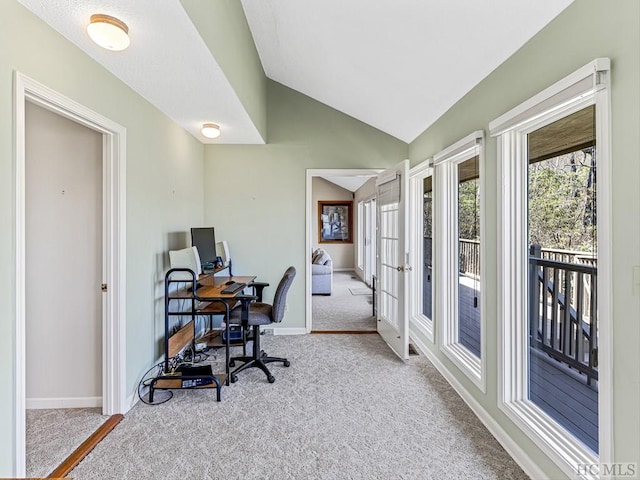 carpeted office space featuring lofted ceiling