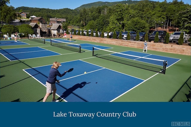 view of tennis court featuring basketball hoop