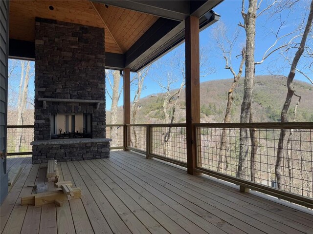 99 Sori Ln, Sapphire, NC 28774 - deck with an outdoor stone fireplace and a mountain view