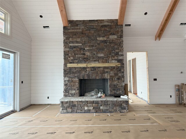 99 Sori Ln, Sapphire, NC 28774 - unfurnished living room with healthy amount of natural light, a fireplace, wooden walls, beam ceiling, and high vaulted ceiling