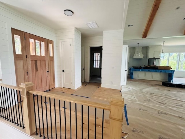 99 Sori Ln, Sapphire, NC 28774 - foyer entrance featuring wood walls, beamed ceiling, and light colored carpet