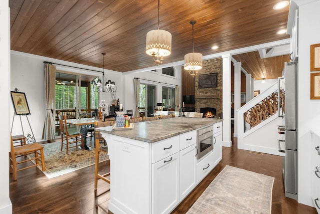 1582 New Settlers Way, Glenville, NC 28736 - kitchen with wood ceiling, stainless steel appliances, light stone counters, a chandelier, and a breakfast bar