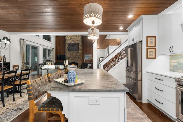 1582 New Settlers Way, Glenville, NC 28736 - kitchen featuring high end refrigerator, wooden ceiling, white cabinetry, a breakfast bar area, and a fireplace