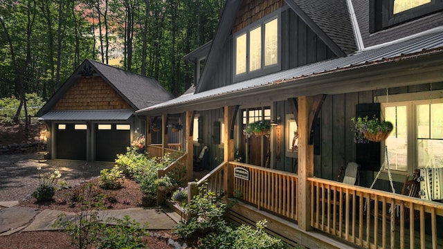 1582 New Settlers Way, Glenville, NC 28736 - view of front of house featuring board and batten siding, covered porch, metal roof, and a shingled roof