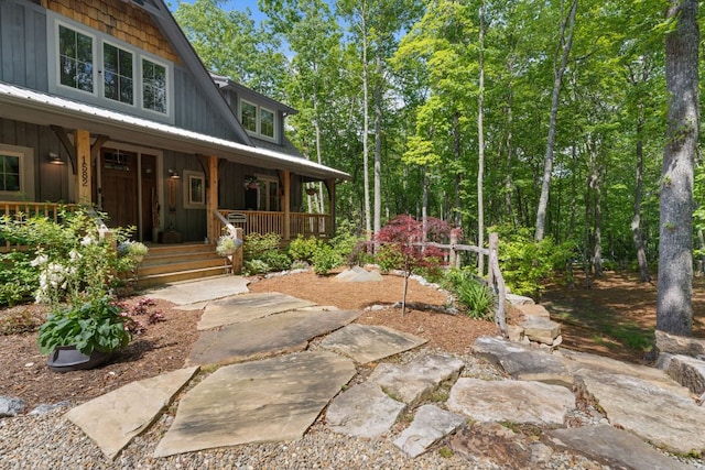 1582 New Settlers Way, Glenville, NC 28736 - view of exterior entry with covered porch, board and batten siding, and metal roof