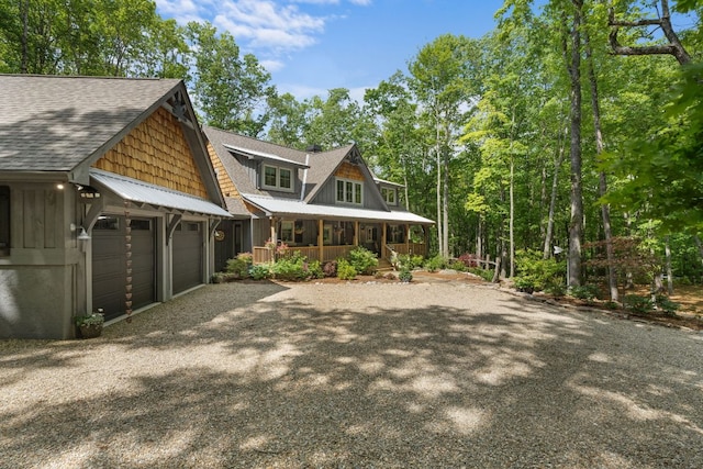 1582 New Settlers Way, Glenville, NC 28736 - view of front of home featuring covered porch, a shingled roof, gravel driveway, a garage, and board and batten siding