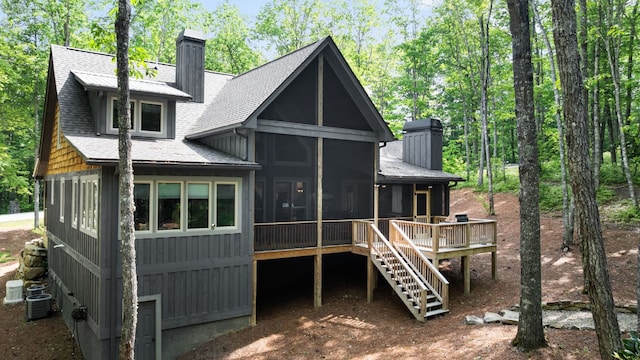 1582 New Settlers Way, Glenville, NC 28736 - back of property featuring a chimney, a sunroom, stairs, central air condition unit, and a shingled roof