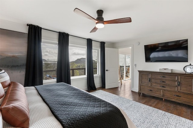 bedroom featuring dark wood-style flooring, baseboards, and a ceiling fan