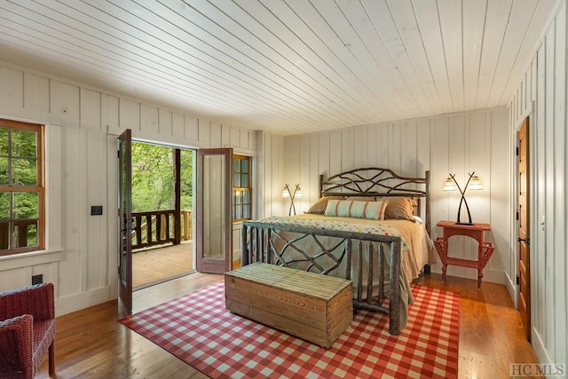 bedroom featuring access to exterior and hardwood / wood-style floors