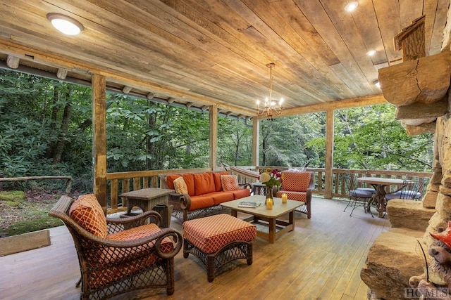 sunroom / solarium featuring a notable chandelier and wooden ceiling