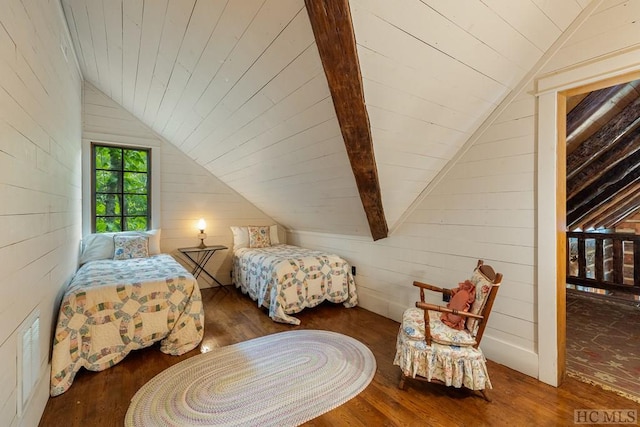 bedroom with dark hardwood / wood-style flooring, vaulted ceiling, and wood walls