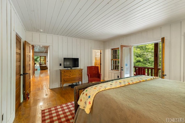 bedroom with hardwood / wood-style flooring, access to exterior, and wood ceiling