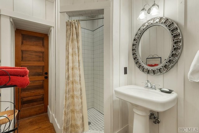 bathroom with wood-type flooring and walk in shower