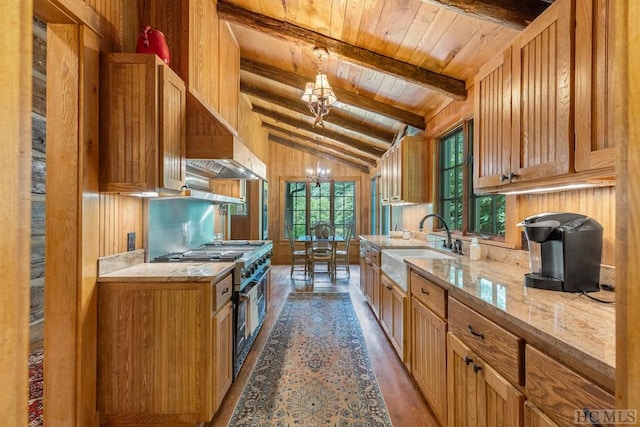 kitchen featuring double oven range, wood ceiling, light hardwood / wood-style flooring, and wooden walls