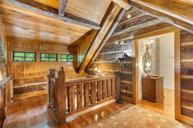 bonus room featuring lofted ceiling, hardwood / wood-style floors, wood ceiling, and wood walls