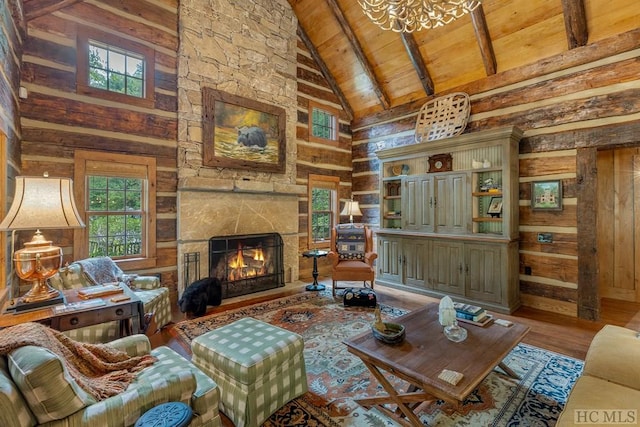 living room with beam ceiling, wood ceiling, high vaulted ceiling, and a healthy amount of sunlight