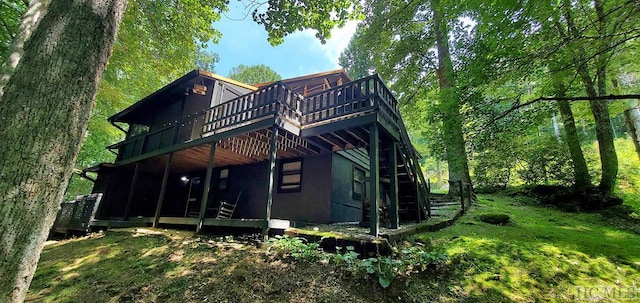 rear view of property with a wooden deck