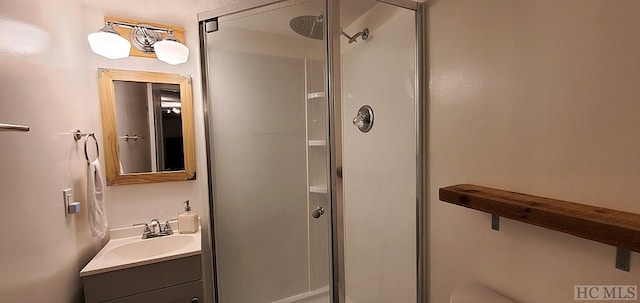 bathroom with an enclosed shower and vanity