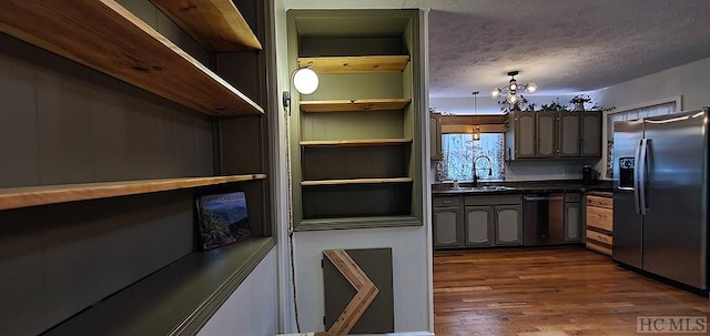 kitchen featuring dishwasher, a textured ceiling, dark hardwood / wood-style flooring, sink, and stainless steel fridge with ice dispenser