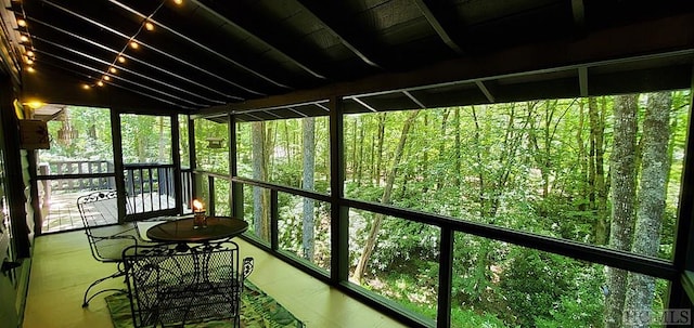 unfurnished sunroom with lofted ceiling