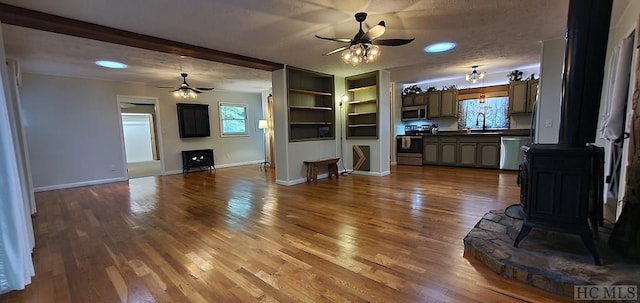 unfurnished living room with wood-type flooring, ceiling fan, and sink