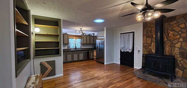 kitchen with stainless steel refrigerator with ice dispenser, sink, dishwasher, a textured ceiling, and dark hardwood / wood-style floors