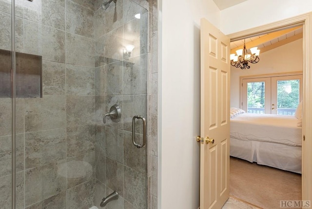 bathroom featuring an enclosed shower, a chandelier, french doors, and lofted ceiling