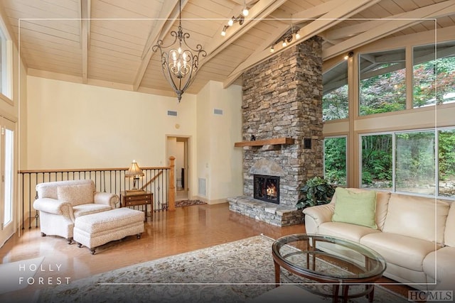 living room featuring beamed ceiling, a fireplace, high vaulted ceiling, and wooden ceiling