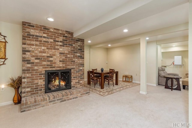 living room with a brick fireplace and carpet