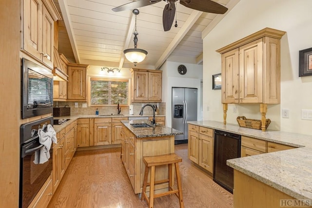 kitchen with beverage cooler, light hardwood / wood-style floors, sink, and black appliances