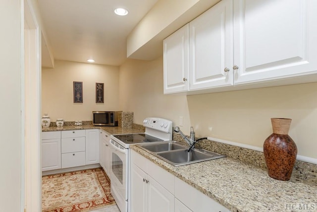 kitchen featuring light stone counters, sink, white cabinets, and white electric range oven