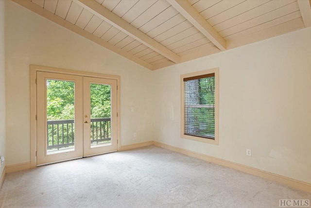 empty room featuring french doors, light colored carpet, and lofted ceiling with beams