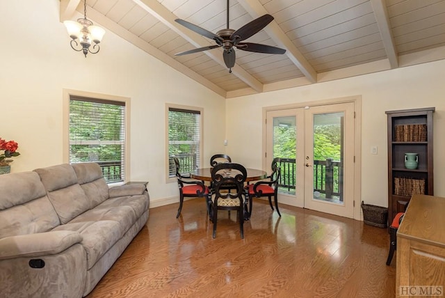 living room featuring hardwood / wood-style flooring, lofted ceiling with beams, ceiling fan with notable chandelier, and french doors