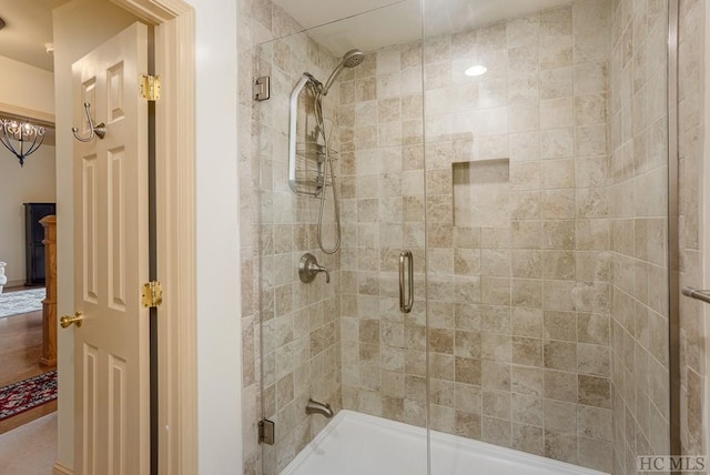 bathroom featuring a shower with door