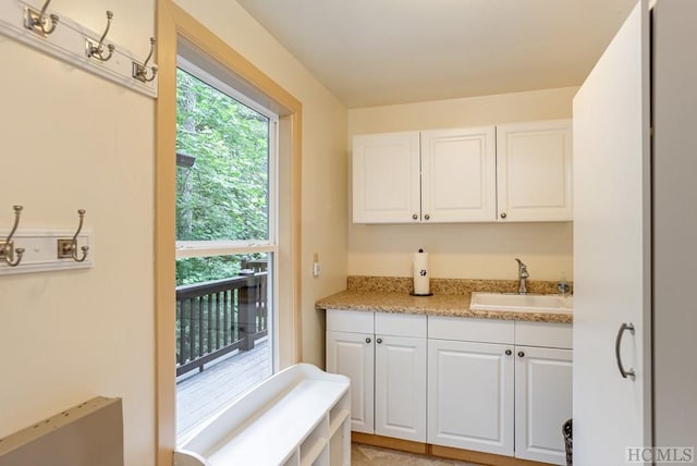 kitchen featuring sink and white cabinets