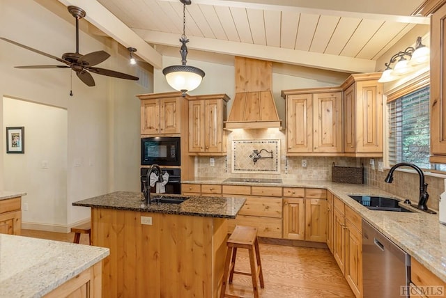 kitchen featuring a center island with sink, sink, light stone counters, lofted ceiling with beams, and black appliances