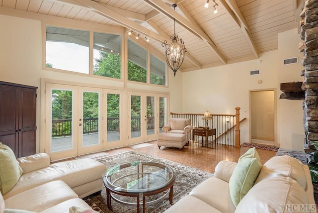 living room with beam ceiling, french doors, high vaulted ceiling, a chandelier, and wooden ceiling