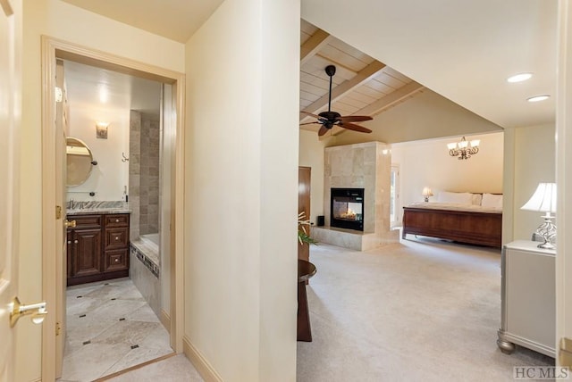 hallway featuring light colored carpet and lofted ceiling with beams