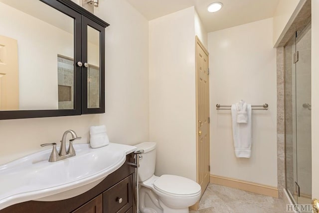 bathroom featuring vanity, an enclosed shower, and toilet